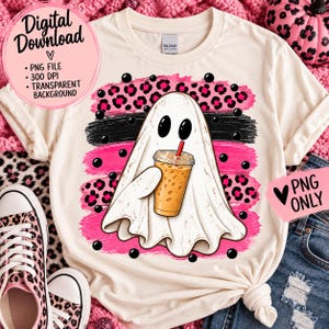 May include: A cream-colored t-shirt featuring a graphic of a white ghost holding an iced coffee. The design includes a pink and black leopard print background with horizontal brush strokes. Text on the image reads Digital Download, PNG File, 300 DPI, Transparent Background, and PNG Only.