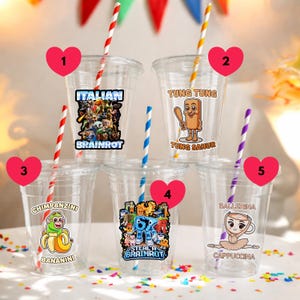 May include: Clear plastic cups with colorful stickers and striped straws. Stickers include the text "Italian Brainrot", "Tung Tung", "Chimpanzini Bananini", "Steal A Brainrot", and "Ballerina Cappuccina".