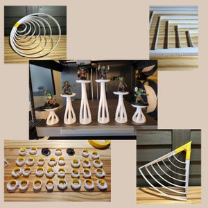 May include: A selection of 3D-printed white objects, including rings, stands, and a maze-like structure. Miniature figurines are displayed on some of the stands. The objects are arranged on a wooden surface.