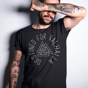 May include: Black t-shirt with a white circle design featuring a stylized triangle symbol and the text "Destined For Valhalla".