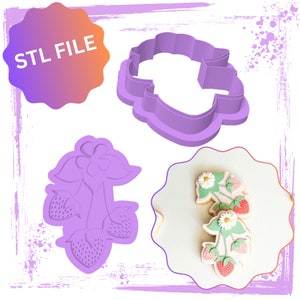May include: STL FILE text on a pink and orange starburst shape. A purple plastic cookie cutter shaped like a flower with three strawberries. A purple plastic cookie cutter shaped like a cloud. A white cookie with green and white icing shaped like a flower with three strawberries.