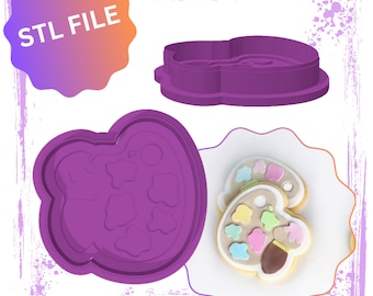May include: Purple plastic cookie cutter shaped like a paint palette with a paintbrush. STL FILE is written on a pink and orange starburst shape.