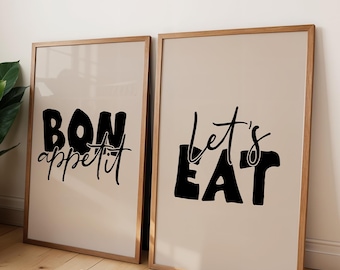 May include: Two framed prints with black text on a beige background. The left print says "Bon appetit" and the right print says "Let's Eat".