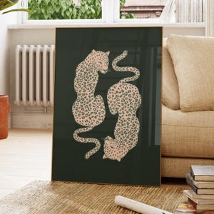 May include: Two pink and black leopard print animals curled up together on a dark green background.