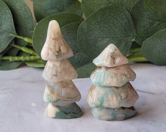 May include: Two carved green and white agate crystal trees. The trees are layered and have a natural, organic look.