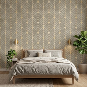 May include: A bedroom featuring wallpaper with a repeating gray and gold fan-shaped geometric pattern. The room includes a wooden bed frame with gray bedding, two wall-mounted gold sconces, and two potted green plants on either side.