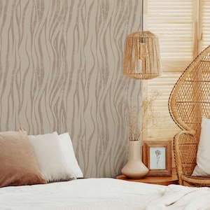 May include: A bedroom scene with beige and brown wavy patterned wallpaper. A woven pendant light hangs from the ceiling. A bed with pillows and a wicker chair are in the foreground. A vase and framed picture sit on a wooden table.