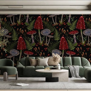May include: A living room interior design featuring a dark green sofa and armchair, a coffee table, and a black wall with a red and green mushroom wallpaper pattern.