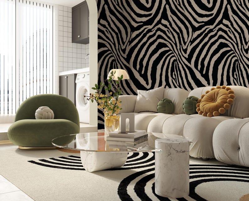 May include: A modern living room with a white sofa, olive green chair, and a marble coffee table. The room features a black and white zebra print accent wall and a patterned rug. Decorative pillows in green and gold add pops of color.