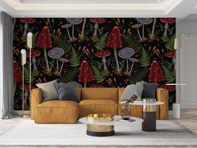 May include: A living room interior with a brown leather sectional sofa and two side tables. The wall behind the sofa is covered with a black and red wallpaper featuring a repeating pattern of mushrooms and ferns.