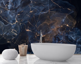 May include: A white bathtub sits in front of a dark blue and gold marble-patterned wall. The bathtub is oval-shaped and has a modern design.