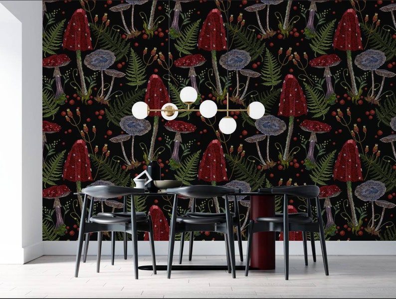 May include: A black and white dining room with a black table and six black chairs. The wall is covered in a red and green mushroom wallpaper.