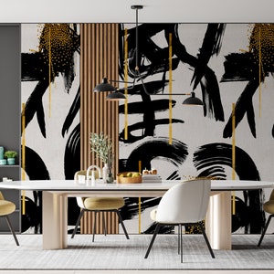 May include: A dining room with a white table and six chairs. The wall behind the table is decorated with a black and gold abstract art print. The print features bold brushstrokes and gold accents.