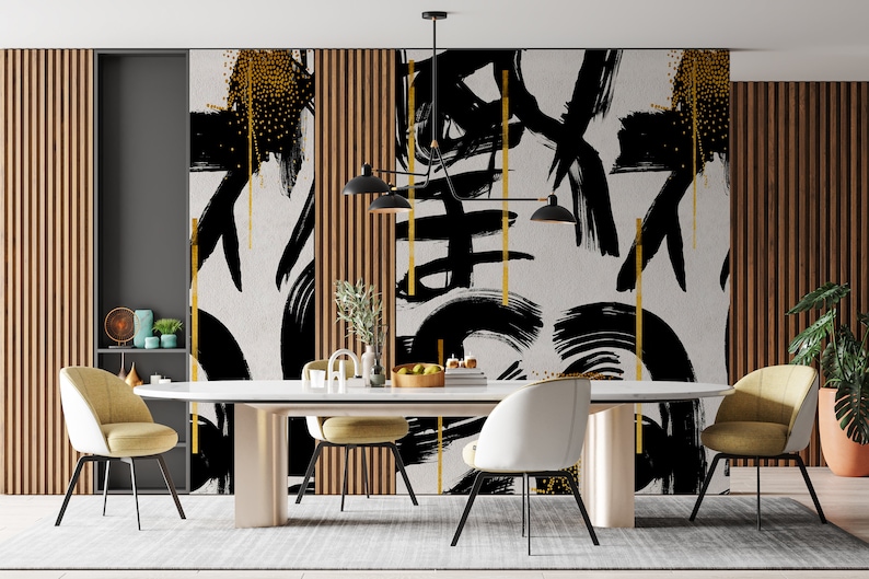 May include: A dining room with a white table and six chairs. The wall behind the table is decorated with a black and gold abstract art print. The print features bold brushstrokes and gold accents.