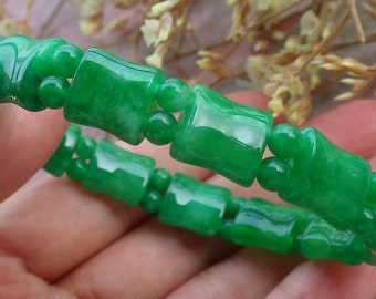 May include: A jade bracelet with green jade beads in a bamboo shape. The bracelet is made of natural jade and is a beautiful piece of jewelry.