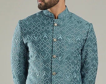 May include: A long-sleeved, teal blue kurta with a white geometric pattern. The kurta has a mandarin collar and a button-up front.