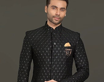 May include: A black patterned long-sleeved jacket with a mandarin collar and a gold embroidered pocket square. The jacket is paired with black pants and brown leather shoes.