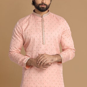 Op de afbeelding: Een roze langarmige kurta met een gouden geborduurd patroon. De kurta heeft een mandarijnkraag en een knoopsluiting.