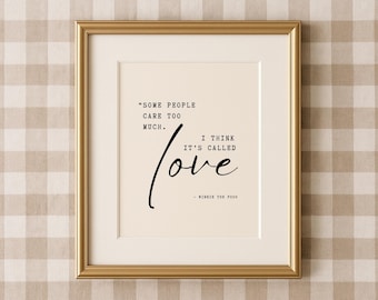 May include: A framed print with a gold-colored frame. The print features the quote "SOME PEOPLE CARE TOO MUCH. I THINK IT'S CALLED love" attributed to Winnie the Pooh, in black script on a cream background.