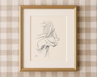 May include: A framed black and white illustration of a bear and a rabbit. The bear is leaning over a wooden structure. The artwork is in a gold frame and set against a cream-coloured mount. The background is a tan and white checked pattern.