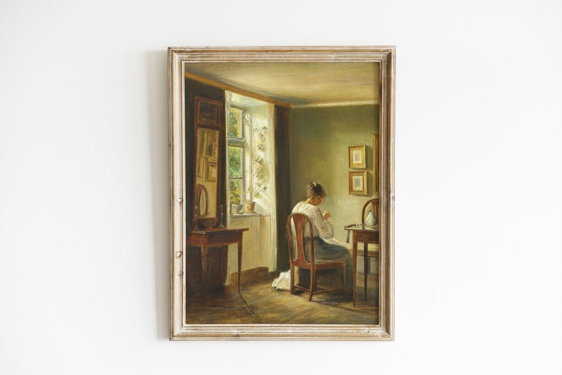 May include: A painting of a woman sitting at a table in a room with a window. The woman is wearing a white dress and is sewing. The room is decorated with a mirror and two framed pictures.
