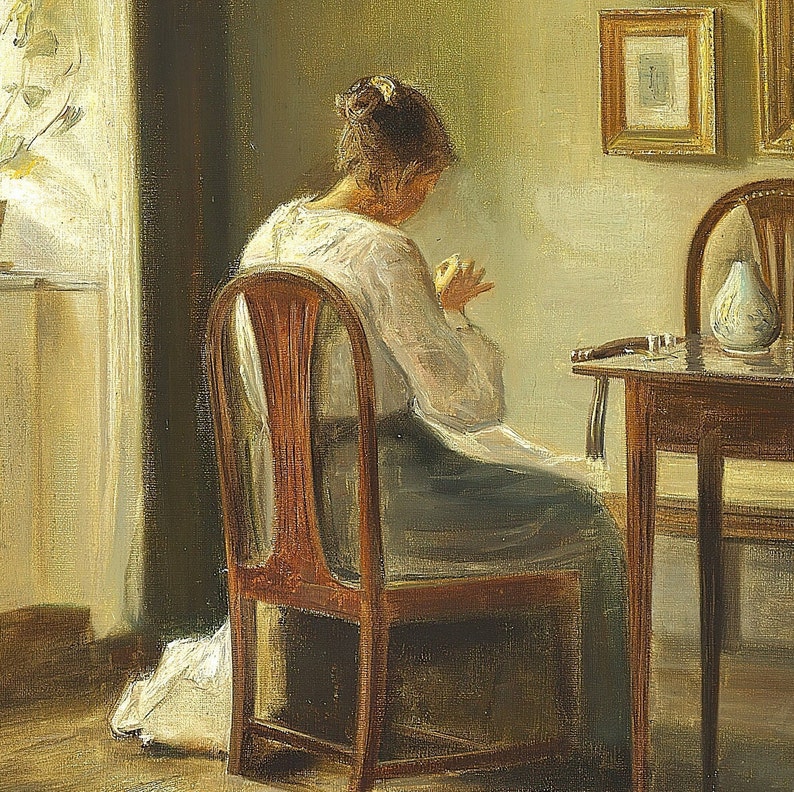 May include: A woman sits in a wooden chair, sewing in a sunlit room. The chair has a high back and a carved design. The woman is wearing a white blouse and a long skirt. There is a table with a vase and a glass on it in the background.