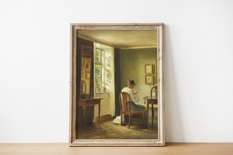 May include: A painting of a woman sitting at a table in a room with a window. The woman is wearing a white dress and is sewing. The room is decorated with a mirror and two framed pictures.