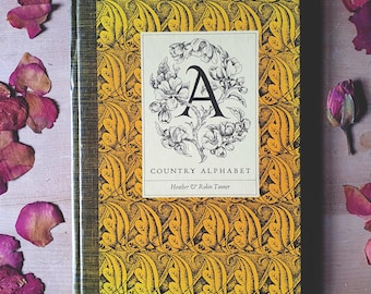 Vintage country alphabet book full of county custom, folklore & wisdom. Illustrated with pretty woodcuts. A little bit witchy.