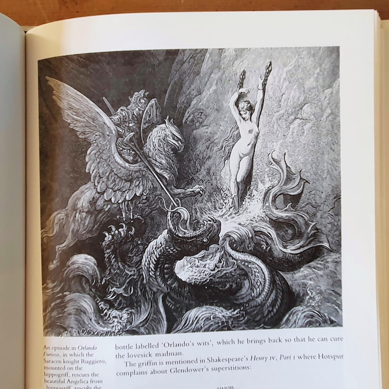May include: Black and white illustration depicting a knight on a griffin battling a sea serpent, with a nude figure in the water. The image is from a book and includes text about the scene.
