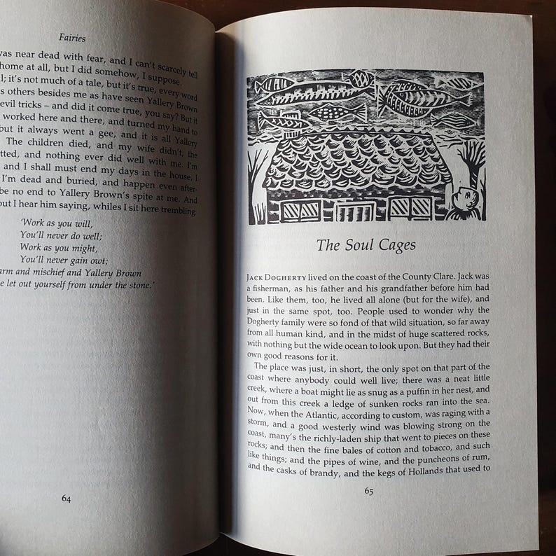 May include: Open book with text and a black and white illustration of a house with fish above it. The text reads "The Soul Cages" and is from a book about fairies.