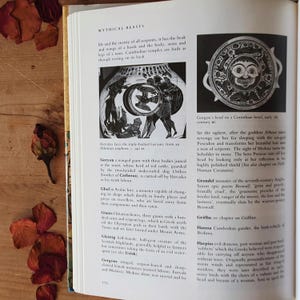 May include: Open book with the title "MYTHICAL BEASTS" and illustrations of mythological creatures. Includes a Corinthian bowl with a Gorgon's head and a depiction of Hercules facing Geryon.