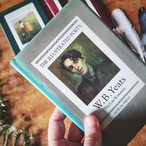 Puede incluir: Un libro azul turquesa con una cubierta blanca que presenta un retrato de W.B. Yeats. El t&iacute;tulo dice "The Illustrated Poets" y "W.B. Yeats The Last Romantic" con el logotipo de Aurum Press en la parte inferior.