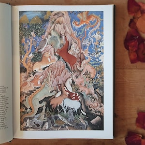 May include: A vibrant, detailed illustration from a book, featuring a fantastical scene with various animals and creatures. The artwork showcases a mountain, a phoenix, lions, and other animals in a colorful, detailed style. The background is a mix of blue, green, and brown.