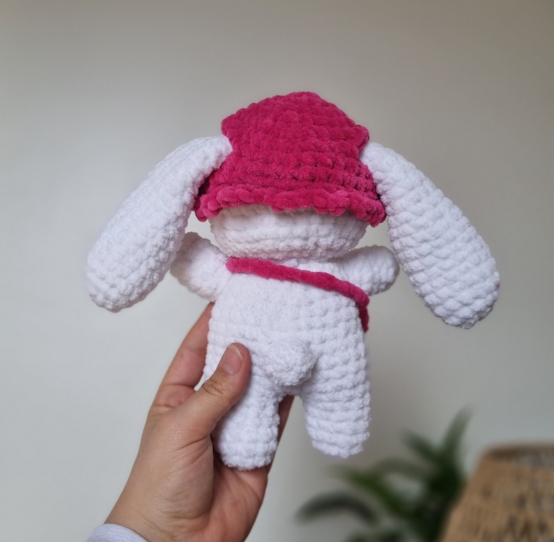 Lapin amigurumi au crochet en laine chenille blanc avec un chapeau rose et un sac rose de dos