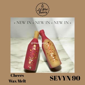 May include: Two wax melt bottles in the shape of champagne bottles. One is pink with gold glitter, the other is yellow with gold glitter. The text "Cheers Wax Melt" and "SEVYN 90" are visible.