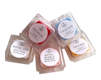 May include: Five small square wax melts in clear plastic containers. The wax melts are in the colors red, blue, yellow, pink, and white. The labels on the containers read "Ardour", "Turquoise", "Swizzle", "Royal Bubbly", and "Hotel Spa".