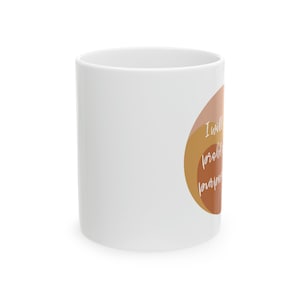 May include: White ceramic mug with a brown and orange abstract design and the text "I will probably overthink this but I'm going to try anyway".