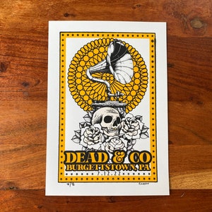 May include: A yellow and black concert poster with a vintage gramophone, skull, and roses. The text reads "Dead & Co. Burgettstown, PA 7.12.22".