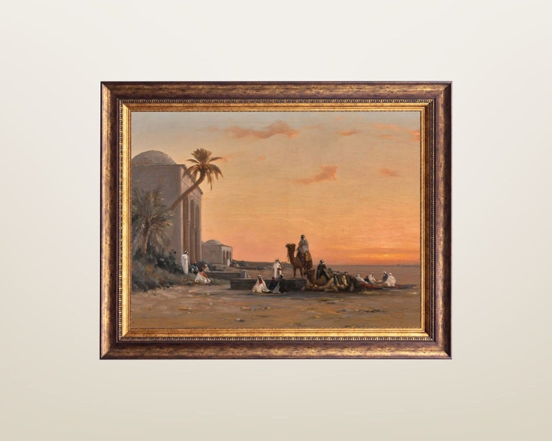May include: A framed painting depicting a desert scene with a group of people and camels in the foreground. The painting is set against a backdrop of a building with a palm tree and a sunset sky.
