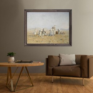 a framed painting of Bedouins in the desert