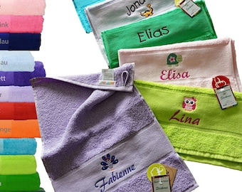 May include: A stack of towels in various colors with names embroidered on them. The names include Lilly Rosa, Jonas, Elias, Elisa, Lina, and Fabienne. The towels are arranged in a rainbow pattern.