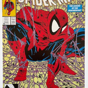 May include: Comic book cover showing Spider-Man in a red and blue costume, surrounded by spiderwebs. The title "Spider-Man" is visible. The cover includes the text "Torment Part One of Five" and the Marvel Comics logo.