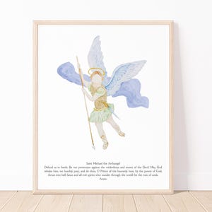 May include: Watercolor print of Saint Michael the Archangel in a light wood frame. The artwork depicts an angel with blue wings, a gold halo, and a spear. The angel is wearing a gold and green outfit. Text at the bottom reads "Saint Michael the Archangel".