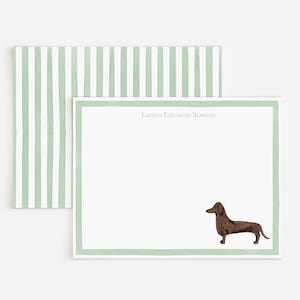 May include: A rectangular white stationery card with a light green border and a brown dachshund illustration in the bottom right corner. The name Lauren Elizabeth Roberts is printed at the top. An envelope with light green vertical stripes is included.