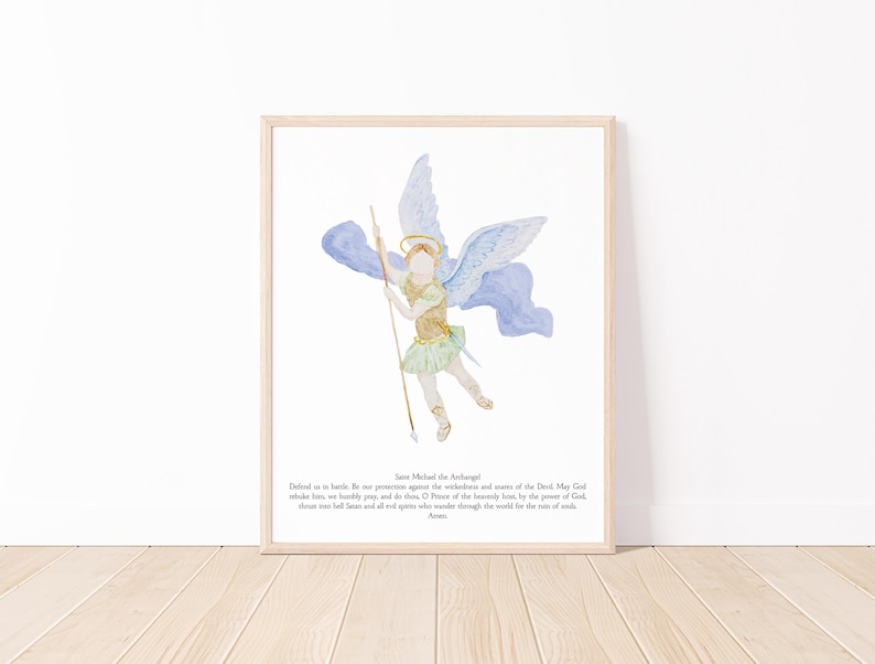 May include: Watercolor print of Saint Michael the Archangel in a light wood frame. The artwork depicts an angel with blue wings, a gold halo, and a spear. The angel is wearing a gold and green outfit. Text at the bottom reads "Saint Michael the Archangel".