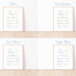 May include: Four framed art prints with the quote "Live in the sunshine, swim in the sea, drink the wild air." The prints are in olive, eucalyptus, sea glass, and light blue, with a wooden frame and white background.