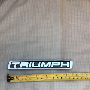 Vintage Triumph Metal Car Grille Badge In Black And Silver