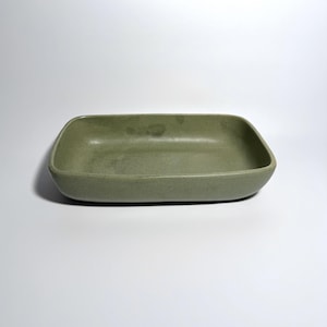 May include: A rustic wooden sign with the text "Welcome to our home" in a handwritten style. The sign is painted white with a distressed finish, and features a simple, elegant design. Perfect for a front door or entryway.