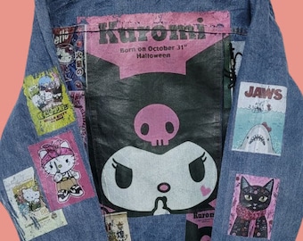 May include: A blue denim jacket with various patches, including a large Kuromi patch with the text "Born on October 31st Halloween", a Jaws patch, and a Hello Kitty patch.