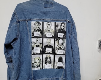 May include: A blue denim jacket with a patch on the back featuring a lineup of horror movie characters, including Freddy Krueger, Jason Voorhees, Michael Myers, and Ghostface. Each character is labeled with their respective film release year.